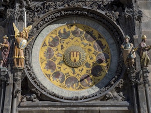caption: The clock announces every hour with 12 apostles passing by the window above the astronomical dial and with symbolic sculptures moving aside.