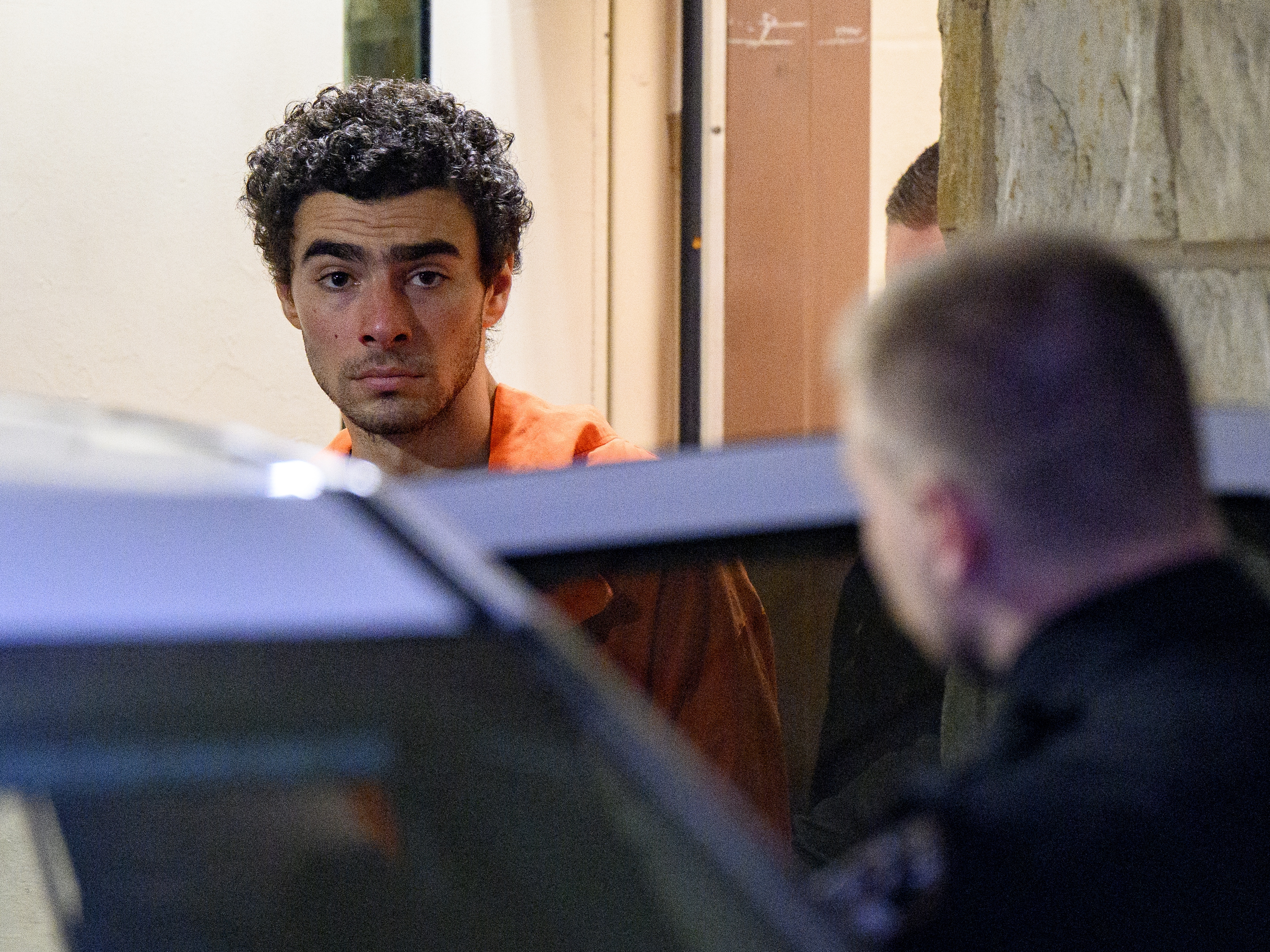 caption: Luigi Mangione is led from the Blair County Courthouse after an extradition hearing on Dec. 10 in Hollidaysburg, Pa.