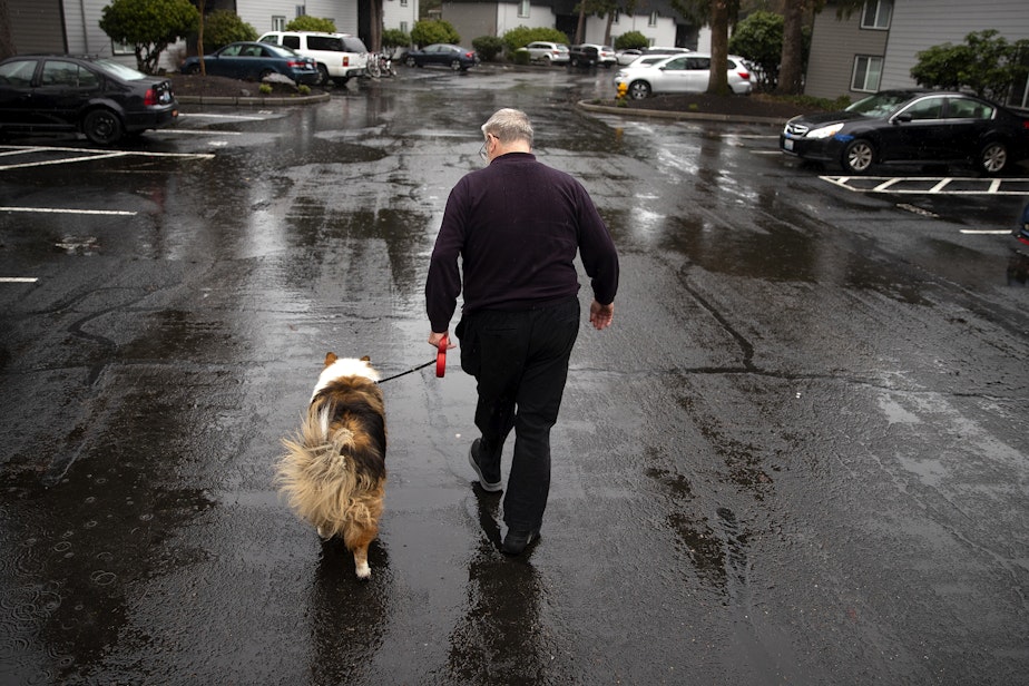 caption: Ned Beck walks with his 12-year-old dog Bud outside of his apartment on Wednesday, February 28, 2024, in Auburn. 