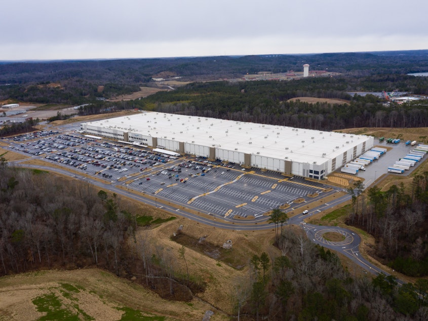 caption: Vote tally begins in a union election at Amazon's warehouse in Bessemer, Ala., pictured here on Feb. 6.