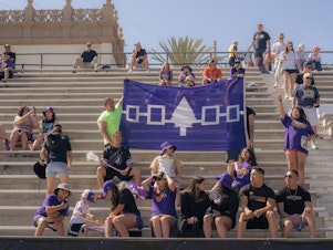 caption: Supporters hold up a banner displaying the Haudenosaunee Confederacy as they cheer for the Haudenosaunee Nationals during a July 23, 2023 match against England in San Diego, Calif.