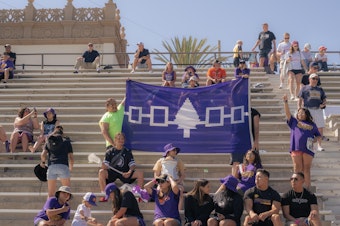 caption: Supporters hold up a banner displaying the Haudenosaunee Confederacy as they cheer for the Haudenosaunee Nationals during a July 23, 2023 match against England in San Diego, Calif.