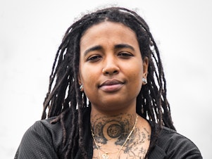 caption: Chantaneice Kitt in Austin, Texas, as part of <em>Exploring Self-Care with QPOC project, </em>that documents the ways various queer people of color living in central Texas heal and care for themselves. For Kitt, the act of getting tattoos is a way to reclaim their ancestral knowledge and traditions and take their pain into their own hands, giving them the power to control the outcome.