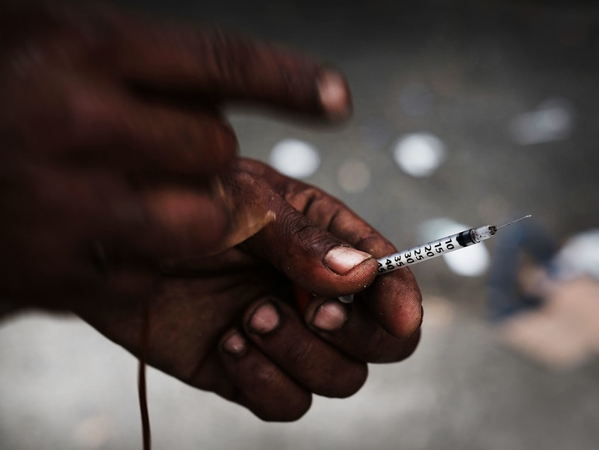 caption: A heroin user in a South Bronx neighborhood which is experiencing an epidemic in drug use, especially heroin and other opioid based drugs.