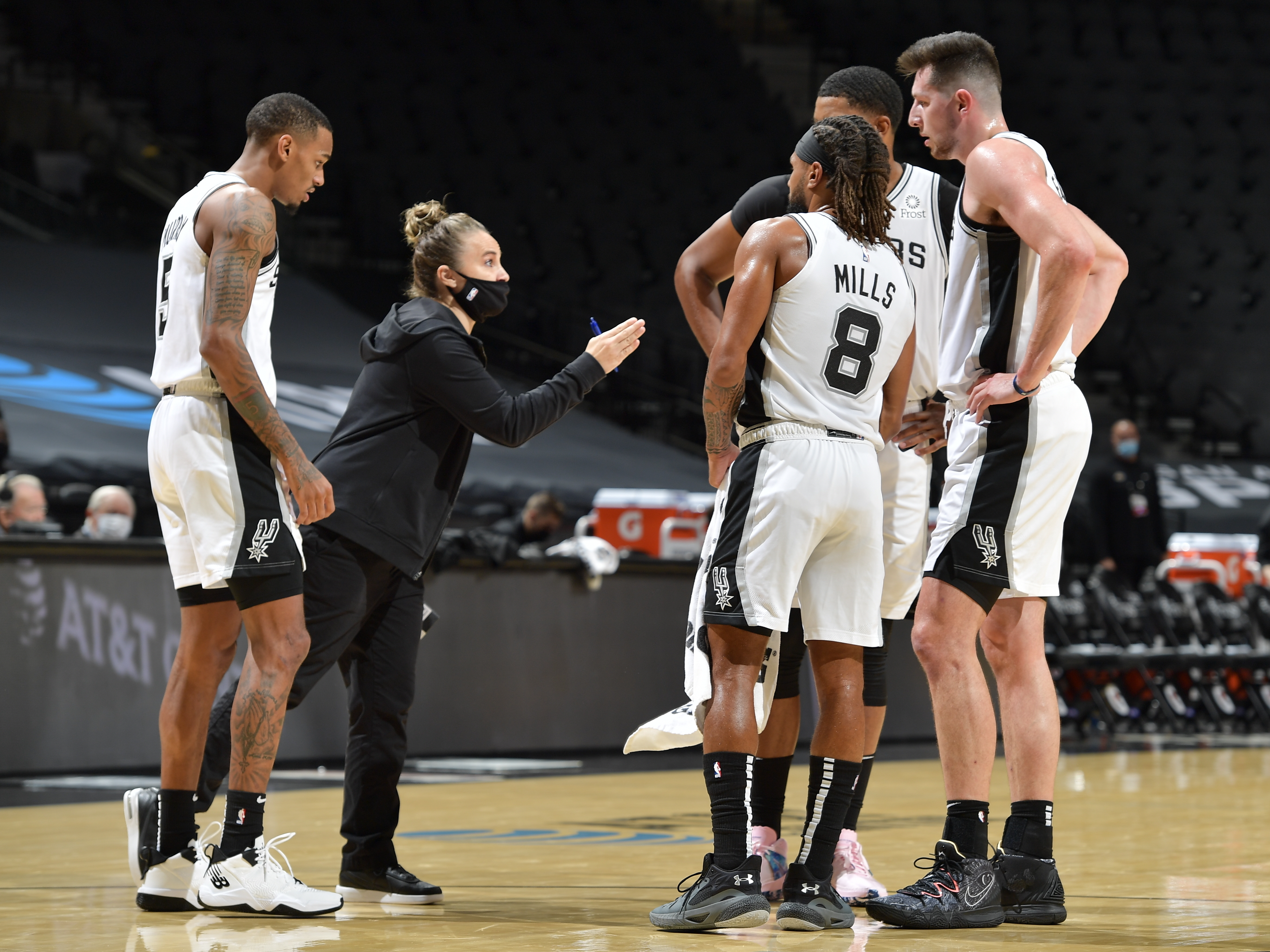 caption: San Antonio Spurs assistant coach Becky Hammon made NBA history Wednesday, becoming the first woman to lead a team in the regular season. She's seen here talking to her players as they faced the Los Angeles Lakers at the AT&T Center in San Antonio.