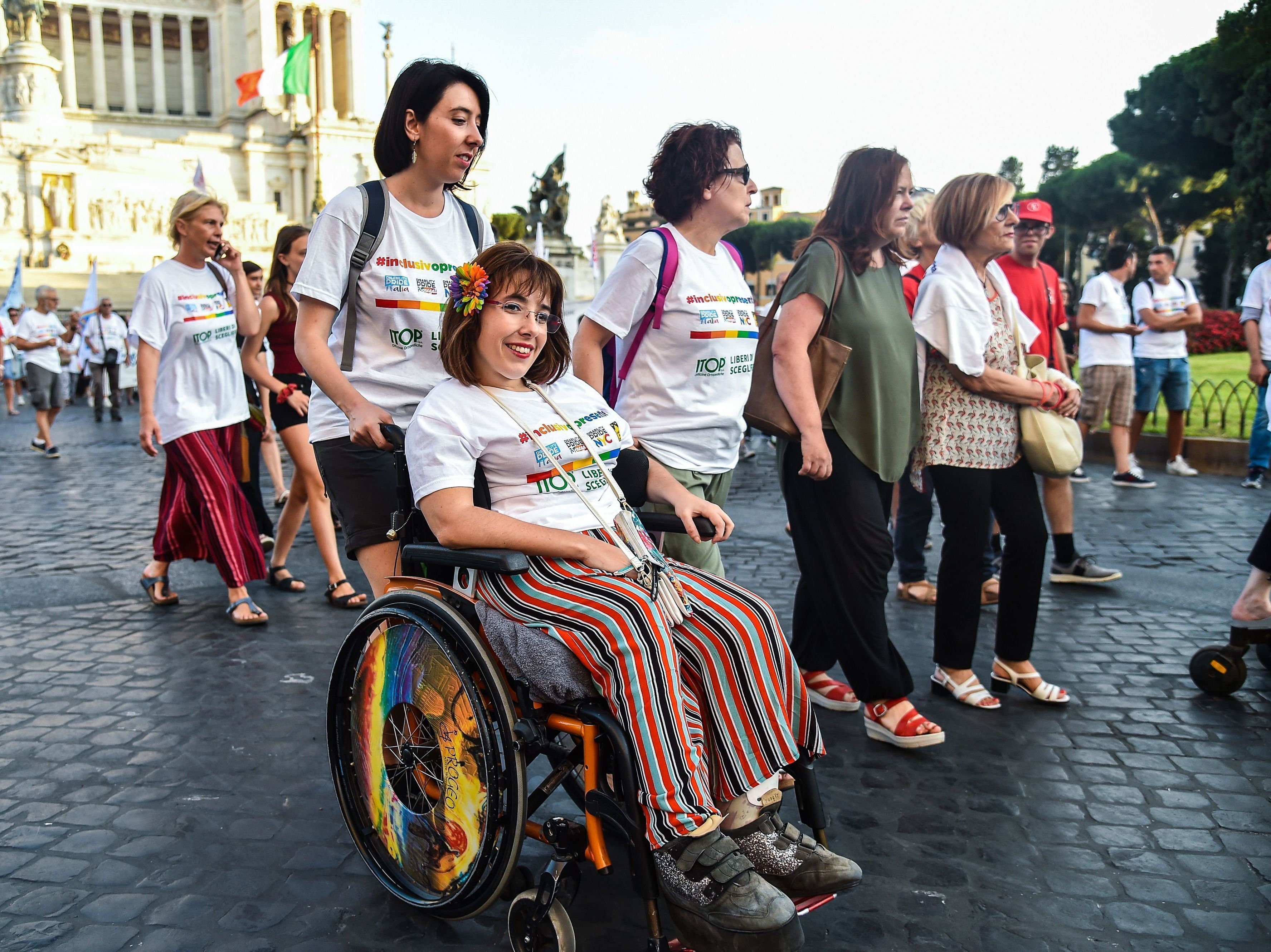 caption: People take part in a disability pride parade on July 14, 2019, in central Rome.