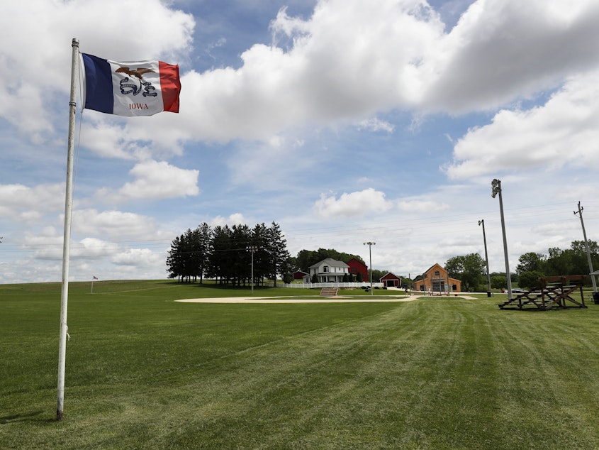 caption: An Iowa flag waves over the field at the Field of Dreams movie site in Dyersville, Iowa, on June 5, 2020.