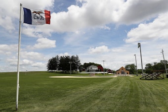 caption: An Iowa flag waves over the field at the Field of Dreams movie site in Dyersville, Iowa, on June 5, 2020.