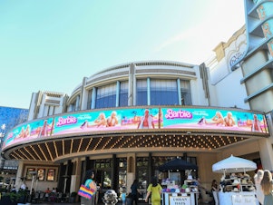 caption: The marquee at The Grove theater in Los Angeles announces the opening of <em>Barbie</em> in July 2023.