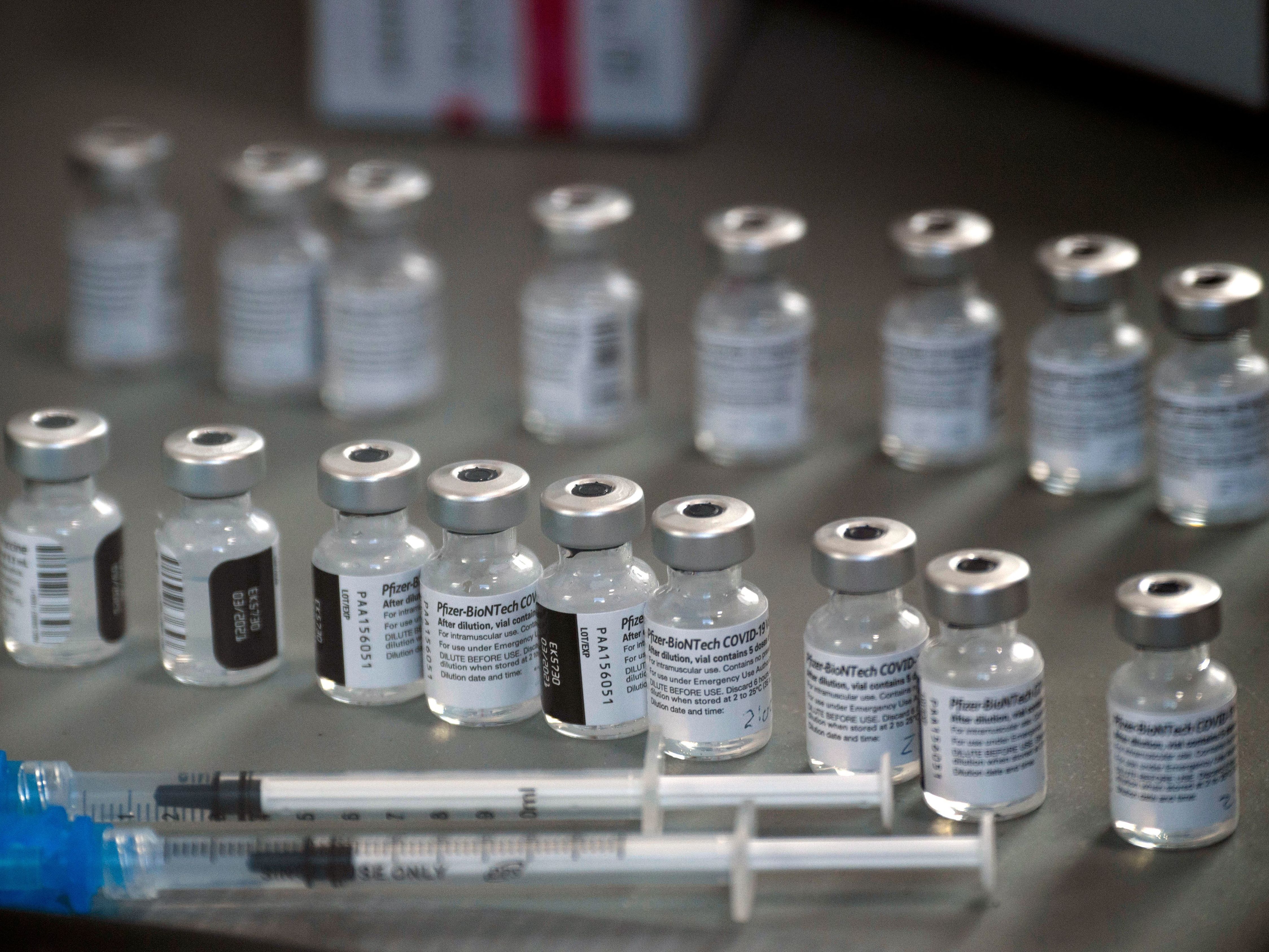 caption: "Pfizer is not having any production issues with our COVID-19 vaccine," CEO Albert Bourla says. But Health and Human Services Secretary Alex Azar says the company has had problems. Many states say their allocations for next week have been cut without an explanation.