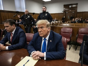 caption: Former president and Republican presidential candidate Donald Trump looks on at Manhattan criminal court during his trial for allegedly covering up hush money payments linked to extramarital affairs in New York on Monday.