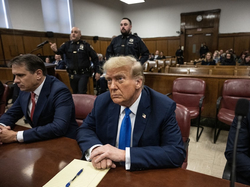 caption: Former president and Republican presidential candidate Donald Trump looks on at Manhattan criminal court during his trial for allegedly covering up hush money payments linked to extramarital affairs in New York on Monday.