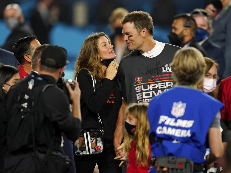 caption: Tampa Bay Buccaneers quarterback Tom Brady walks with Gisele Bundchen on the field in February 2021 after winning the Super Bowl against the Kansas City Chiefs.