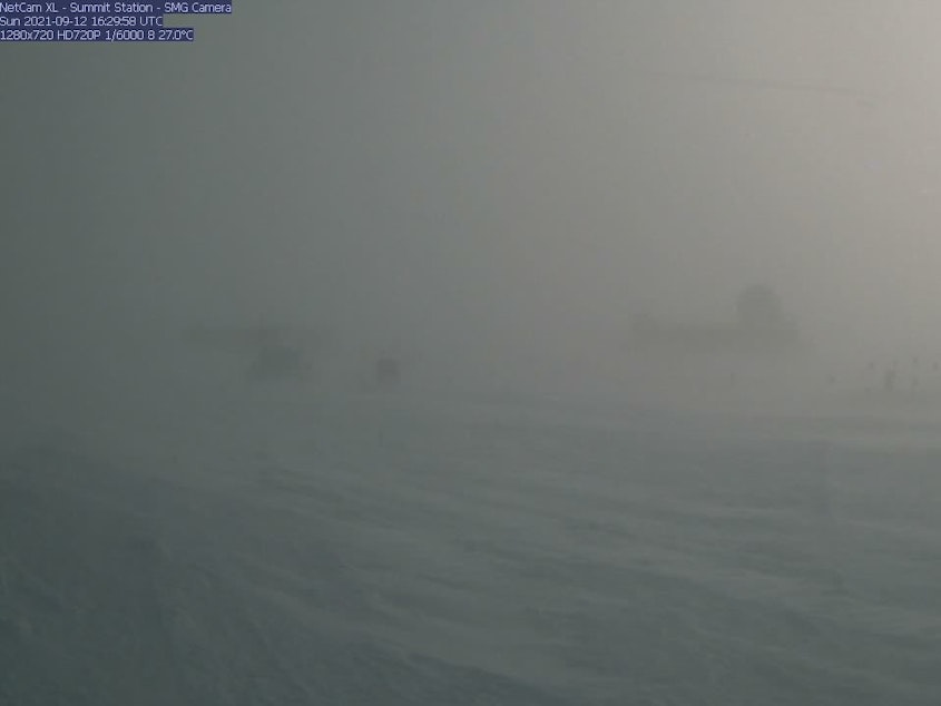 caption: A webcam still showing blizzard conditions at Summit Station, a weather research station at Greenland's highest point. In August, the station recorded rain for the first time ever.