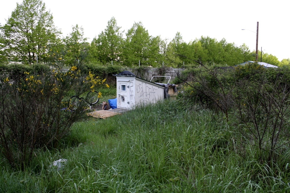 caption: A tiny house near I-5 is part of the 3 mile homeless encampment known as the Jungle.