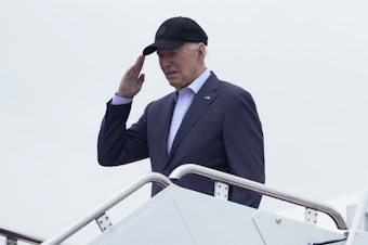 caption: President Biden salutes as he boards Air Force One as he leaves Andrews Air Force Base, Md., on his way to his Delaware home on Friday.