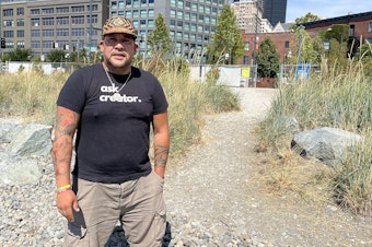 caption: Donny Stevenson, Vice Chairman of the Muckleshoot Tribe, says that while the shoreline has changed a lot in the recent century, this footpath exiting the recently restored Habitat Beach can be thought of as the place most closely associated with original meaning of Alaskan Way's honorary name, Dzidzilalich, which translates to Little Crossing Over Place