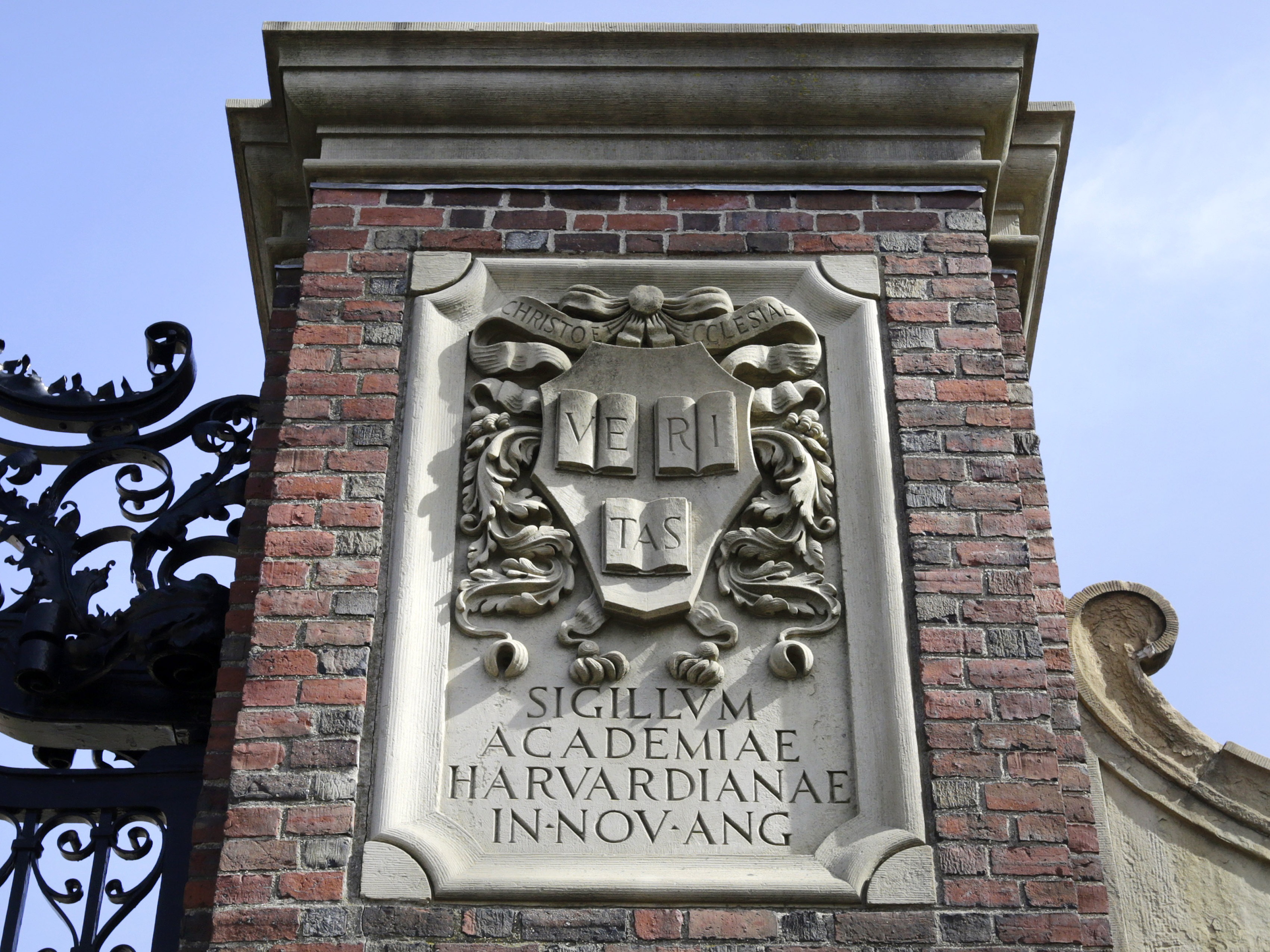 caption: A relief sculpture rests on a gate to the entrance of Harvard University, in Cambridge, Mass., March 13, 2016.