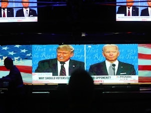 caption: A broadcast of the first debate between President Trump and Democratic nominee Joe Biden is played on TVs at The Abbey in West Hollywood, Calif.