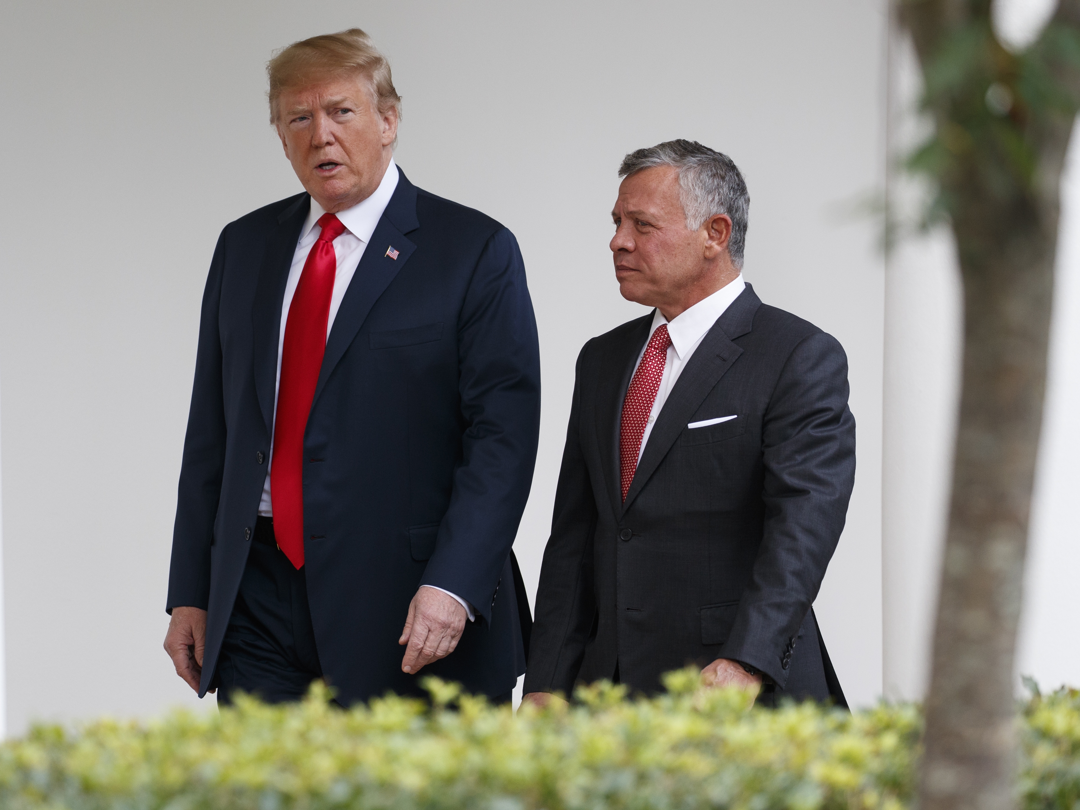 caption: President Trump walks with King Abdullah II of Jordan at the White House, on June 25, 2018, in Washington.