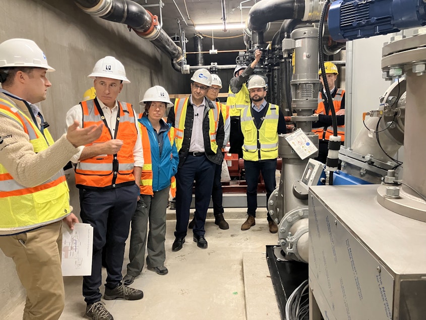 caption: County Executive Dow Constantine, second from left, toured the site in South Lake Union where wastewater will soon be used to heat several commercial buildings. 