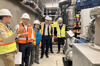 caption: County Executive Dow Constantine, second from left, toured the site in South Lake Union where wastewater will soon be used to heat several commercial buildings. 