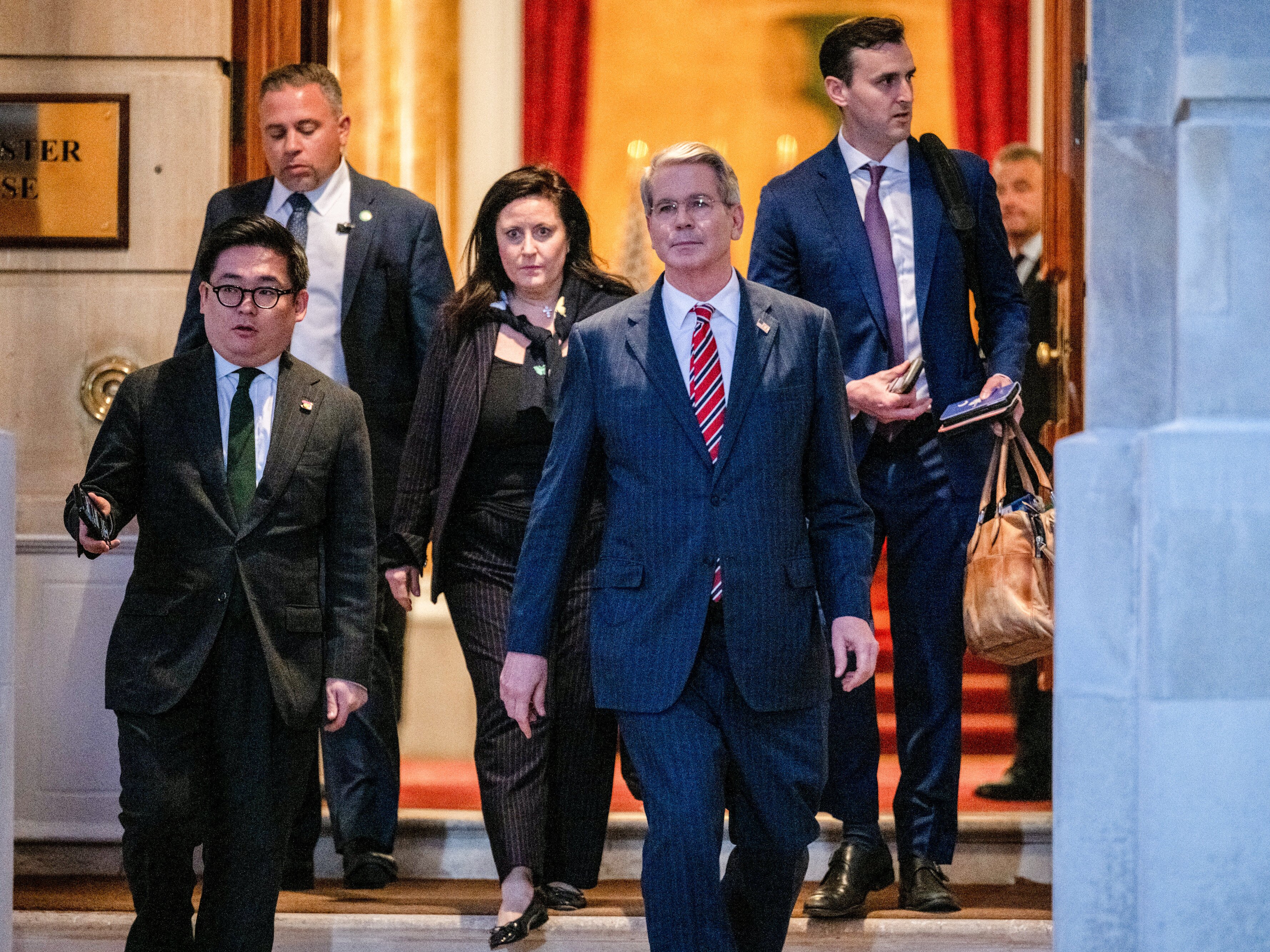 caption: U.S. Treasury Secretary Scott Bessent, second right, departs after trade talks at Lancaster House in London on Tuesday.