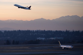 caption: A plane takes off on Monday, Dec. 11, 2017, at Seattle-Tacoma International Airport. 