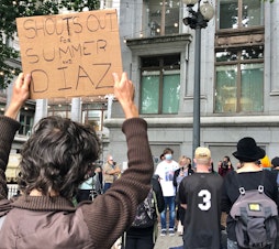 caption: Dalia Taylor, the mother of 24-year-old Summer Taylor who died on July 4 after being struck by a driver during a protest against racism and police violence, addresses a crowd gathered in downtown Seattle for a rally for Taylor and Diaz Love, another protester injured in the collision. 