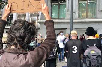 caption: Dalia Taylor, the mother of 24-year-old Summer Taylor who died on July 4 after being struck by a driver during a protest against racism and police violence, addresses a crowd gathered in downtown Seattle for a rally for Taylor and Diaz Love, another protester injured in the collision. 