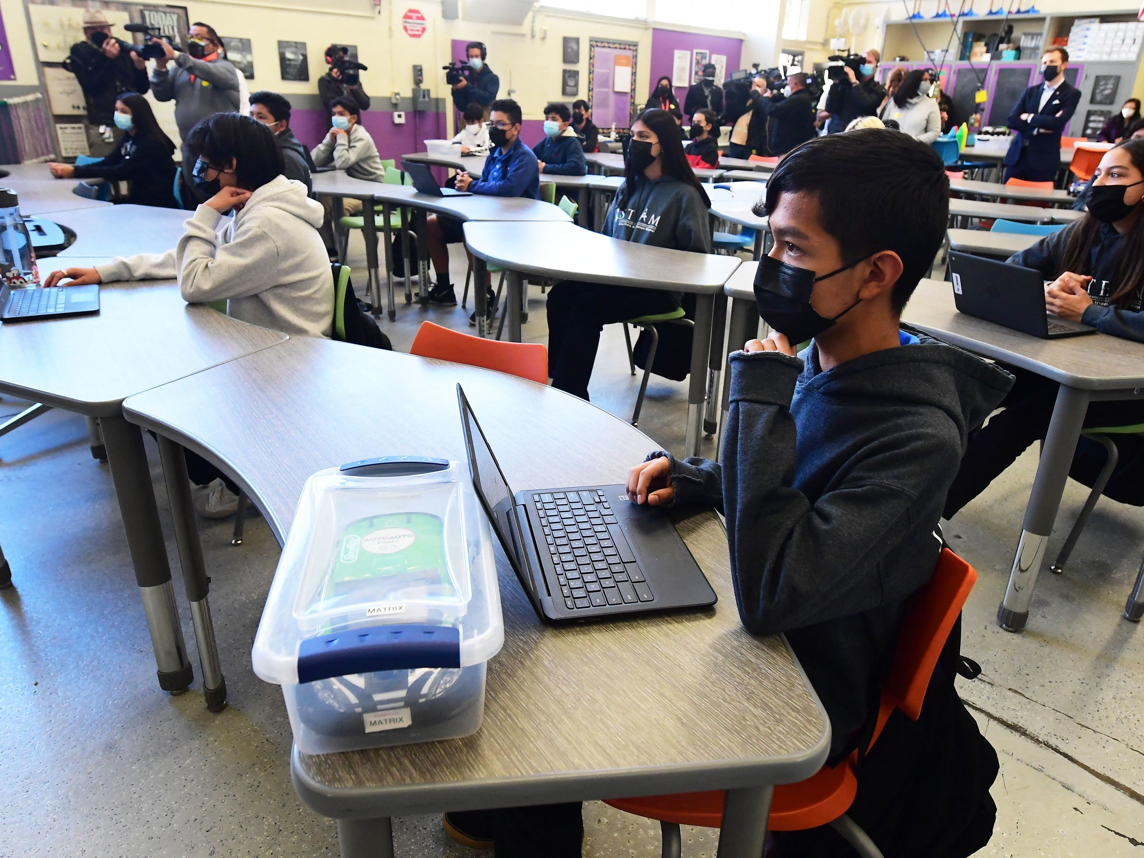 caption: Seventh and eighth grade students attend class at Olive Vista Middle School on Jan. 11 in Sylmar, Calif. Los Angeles students will be required to wear non-cloth masks.