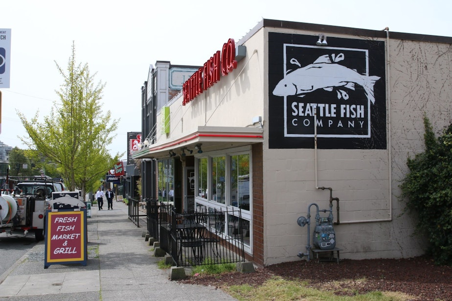 caption: Jon Daniels, owner of the West Seattle Fish Company, says local merchants rely on parking to draw customers. For him, on the outskirts of the urban village, it's street parking. For those closer to the center, it's the free lots run by the West Seattle Junction Association.
