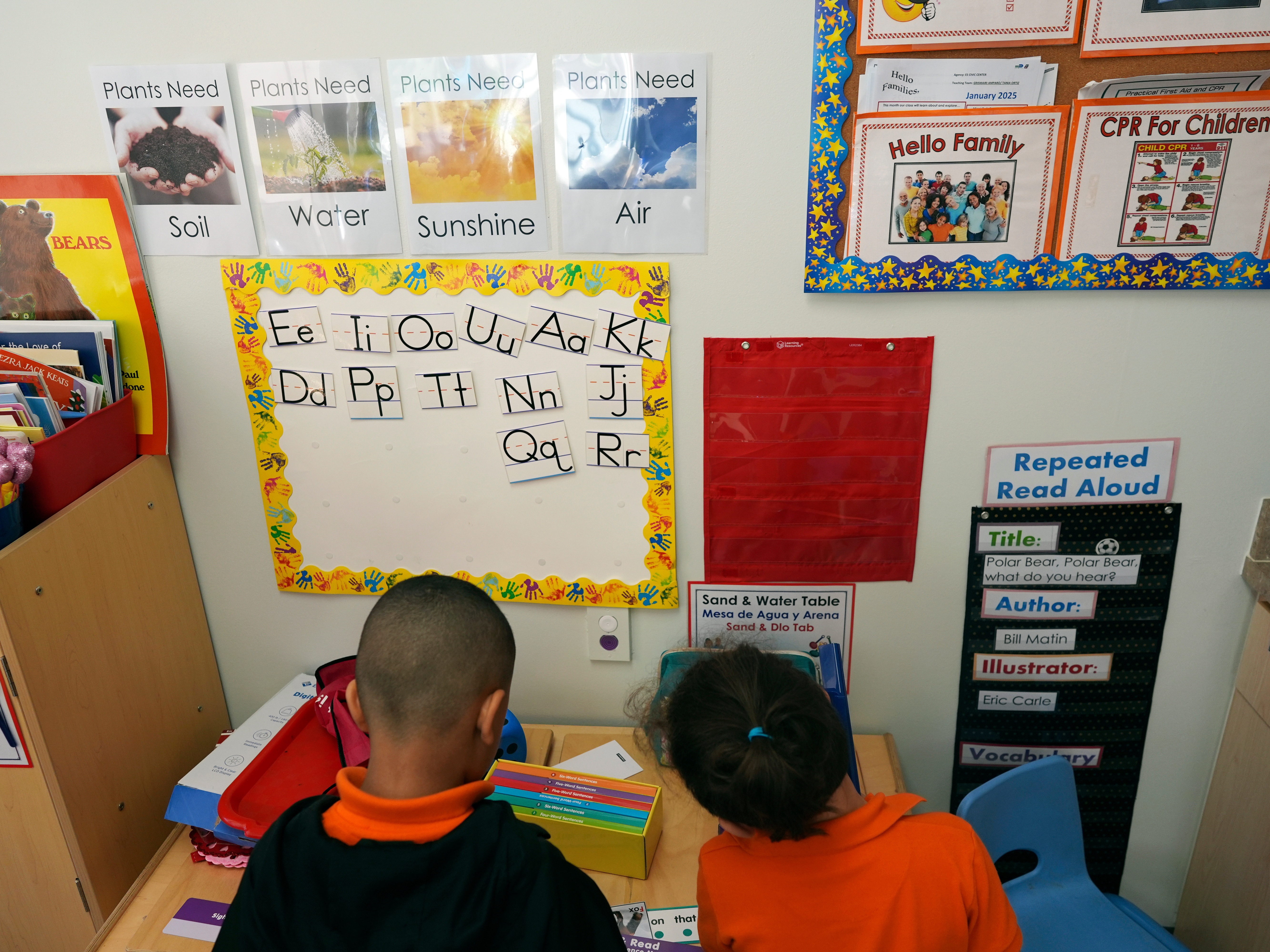 caption: Students help put away supplies at the end of a reading and writing lesson at a Head Start program in Miami in January 2025.