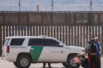 caption: Border Patrol agents apprehend a group of migrants near downtown El Paso, Texas, on Monday. The Department of Homeland Security is struggling to manage a growing number of unaccompanied minors at the border.