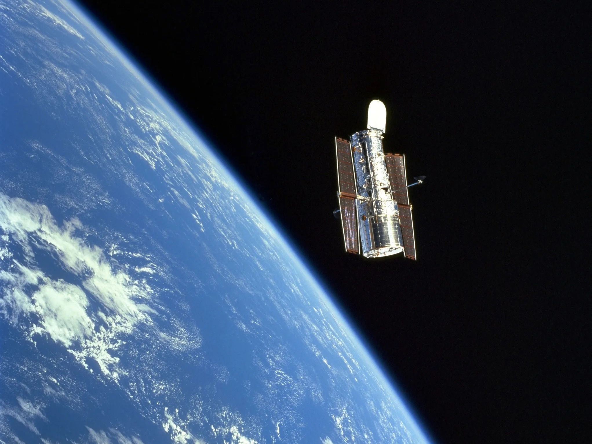 caption:  The Hubble Space Telescope in orbit in 1999, just after a servicing mission by astronauts. 