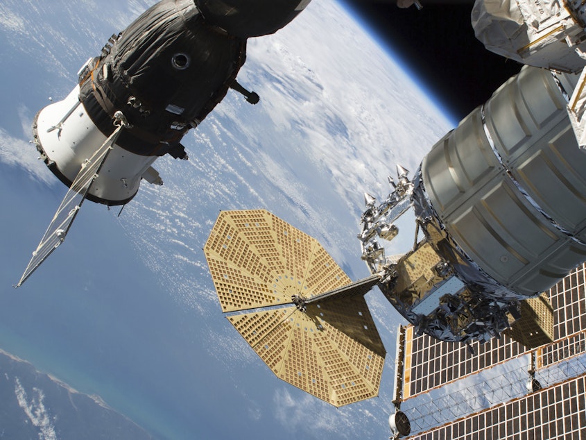 caption: A 2-millimeter hole was found last week in a Russian Soyuz MS-09 spacecraft (left) that is docked to the International Space Station.
