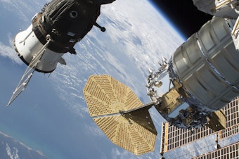 caption: A 2-millimeter hole was found last week in a Russian Soyuz MS-09 spacecraft (left) that is docked to the International Space Station.