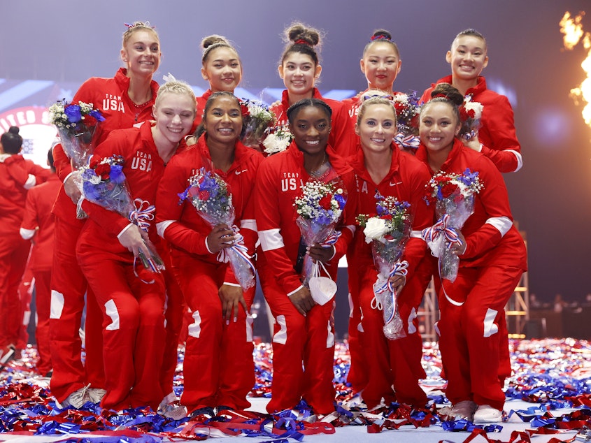 caption: The women representing Team USA, including six team members and four alternates, pose last month after the U.S. Gymnastics Olympic Trials. An unnamed alternate has tested positive for the coronavirus.