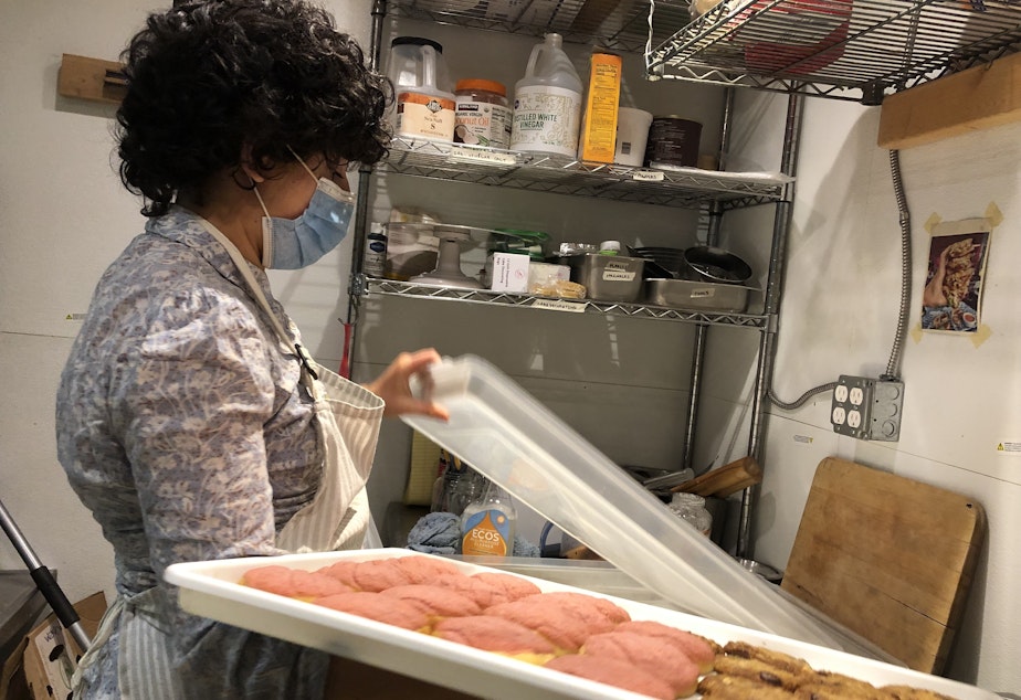 caption: Lara de la Rosa packs up baked goods to transport to the bakery a few blocks away.