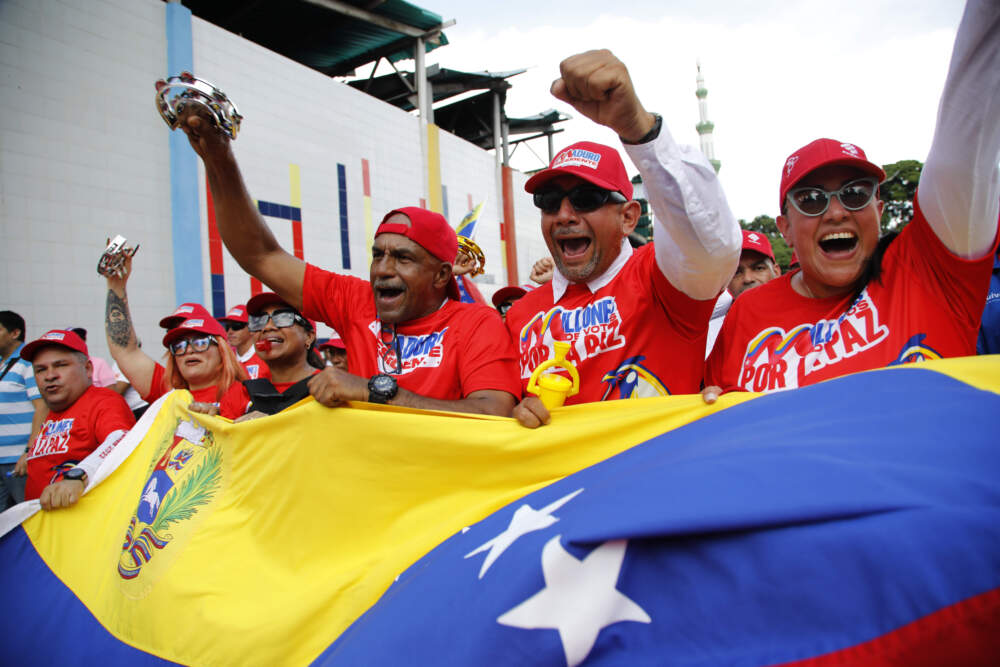 caption: Supporters of Venezuelan President Nicolas Maduro take part in a rally in defense of his reelection on Aug. 3, 2024. (Cristian Hernandez/AP)