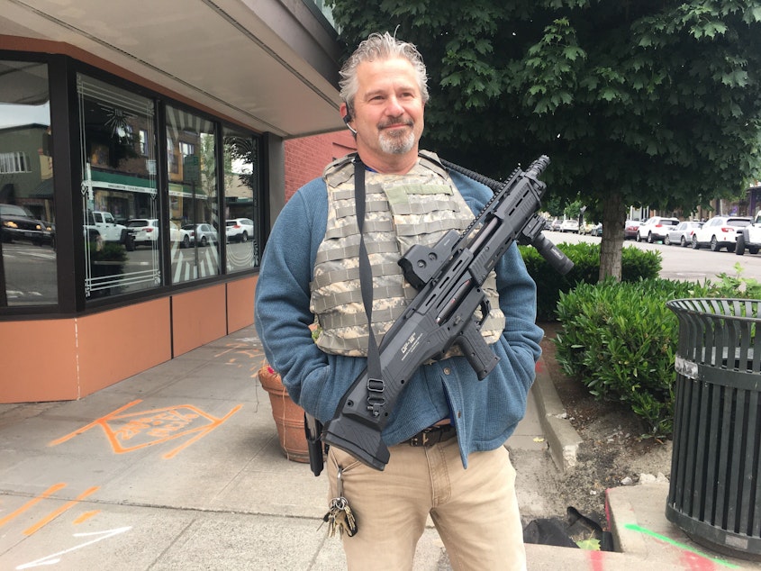 caption: Maurice Whitney is a local Renton resident and property manager. He says he's with the protesters, just not with those inflicting damage. 