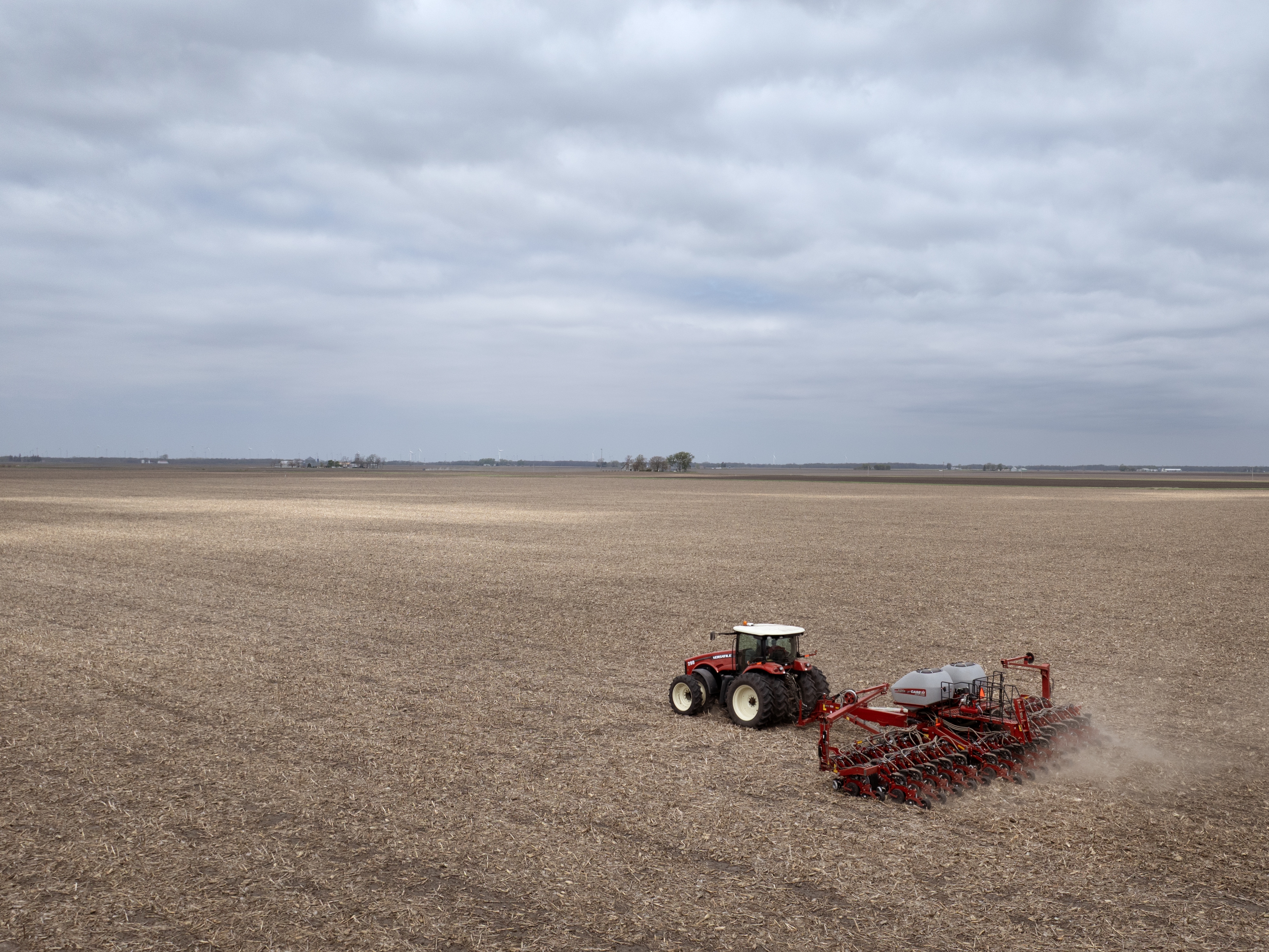 caption: Dan Duffy uses a tractor to plant soybeans on land he farms with his brother on April 28, 2025 near Dwight, Illinois.