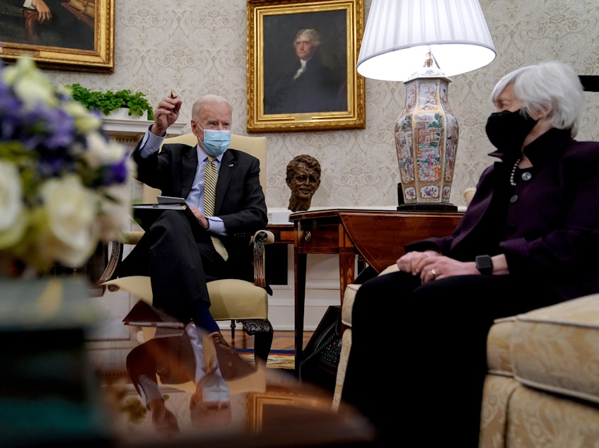 caption: President Biden speaks as Treasury Secretary Janet Yellen listens during the weekly economic briefing in the Oval Office at the White House on April 9. Biden issued an executive order compelling Yellen and other regulators to assess the risk of climate change to America's financial system.