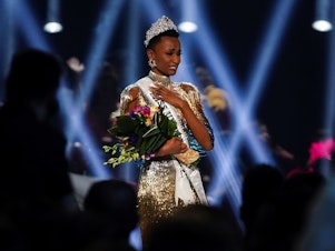caption: Zozibini Tunzi of South Africa takes her first walk as Miss Universe after winning the 2019 Miss Universe pageant.