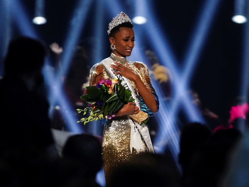 caption: Zozibini Tunzi of South Africa takes her first walk as Miss Universe after winning the 2019 Miss Universe pageant.