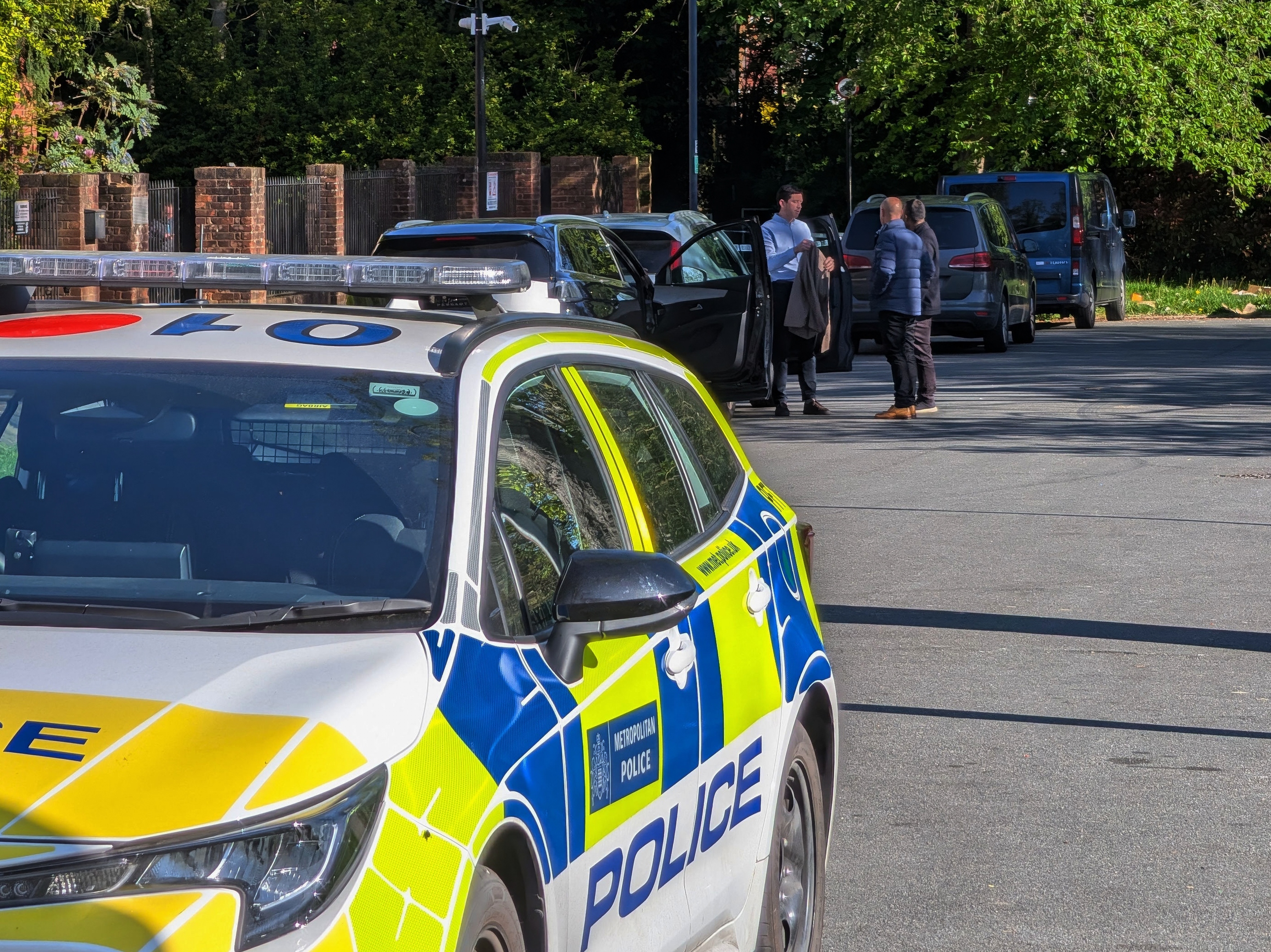 caption: Police officers patrol at a cordon near Kenton United Synagogue in Harrow, a suburb of London, Sunday, April 19, 2026.