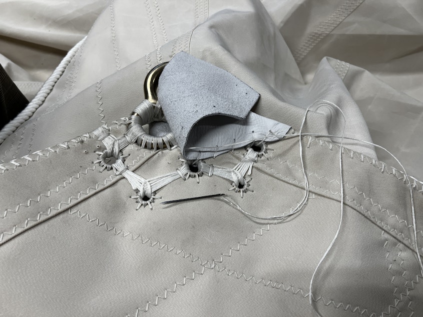 caption: A close up of this corner shows the intricate seamwork that goes into a sail. 