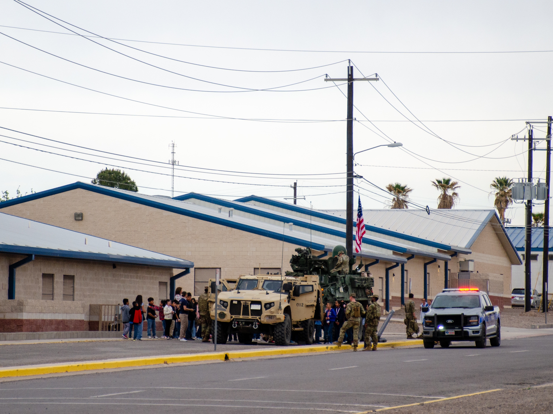 caption: The Army's tactical vehicles on display at an elementary school in the small town of Presidio, Texas. A spokesperson for the Army said the school invited them to help familiarize the community with the Army's presence.