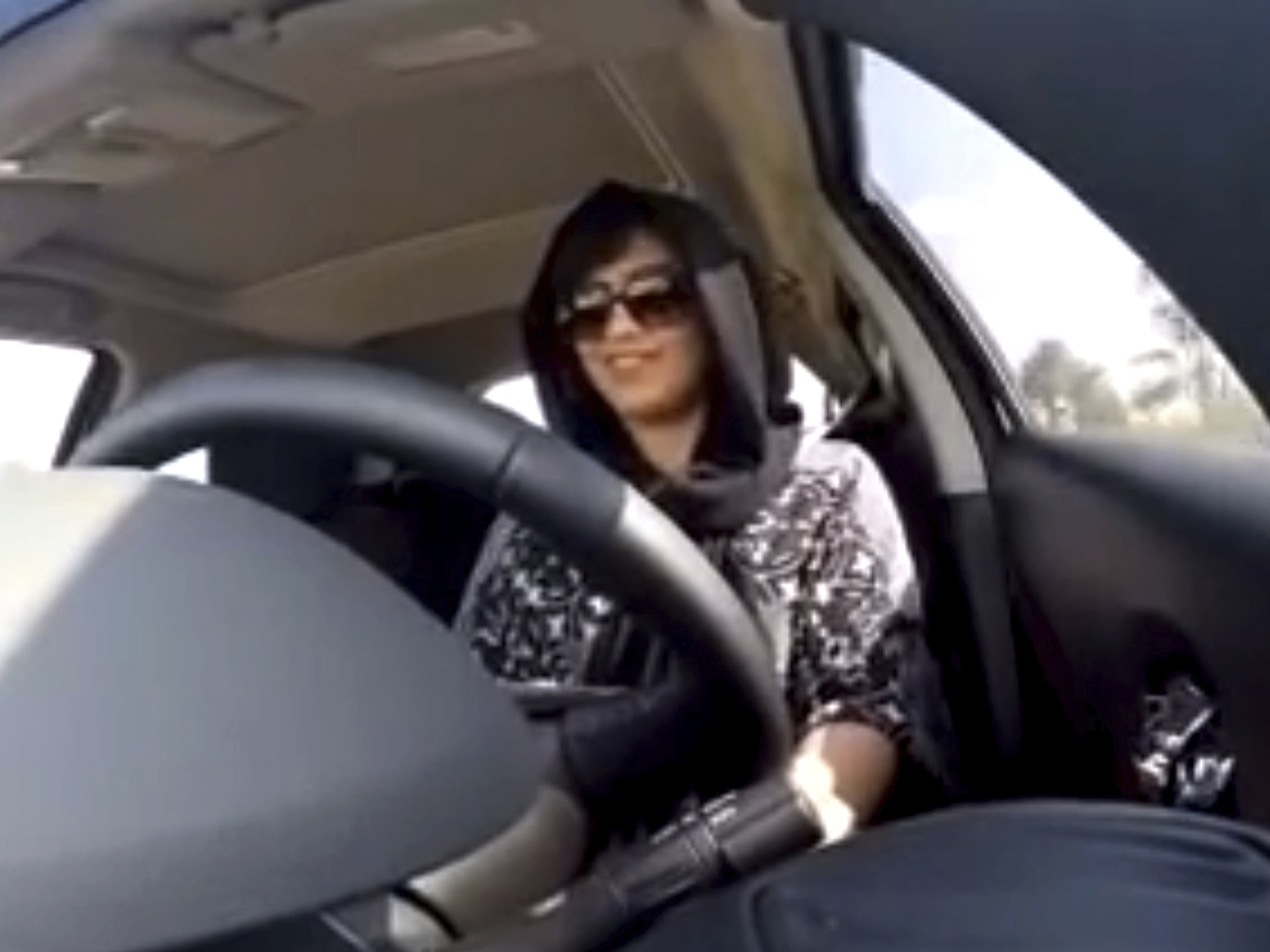 caption: Loujain al-Hathloul in a 2014 image made from video, driving before it was legal for women in Saudi Arabia to do so. Al-Hathloul was sentenced to a six-year prison term Monday.