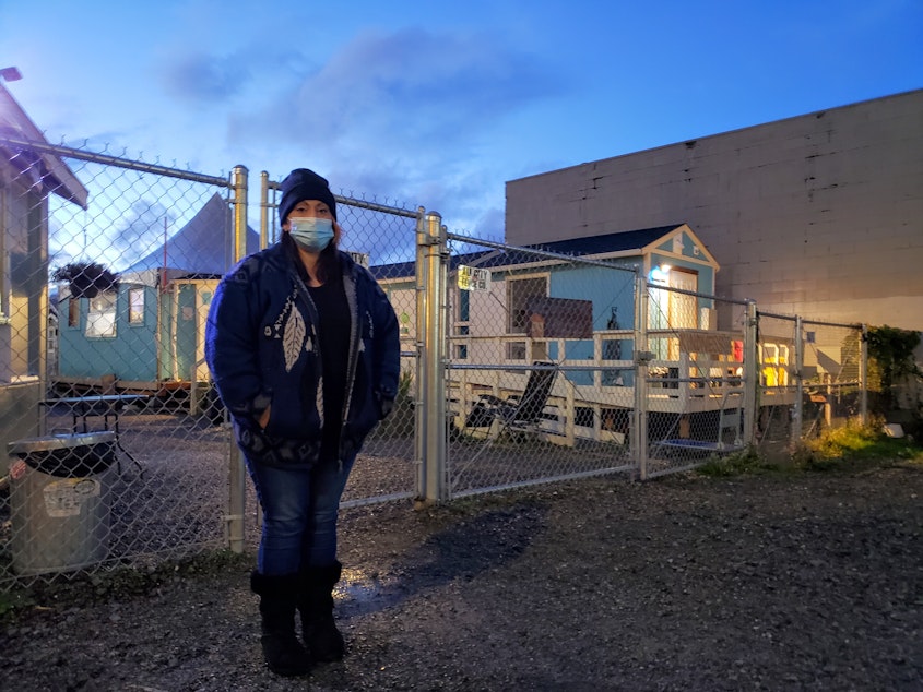 caption: Michelle Crisafi stands outside of Interbay Tiny House Village on Wednesday, November 18, 2020. 